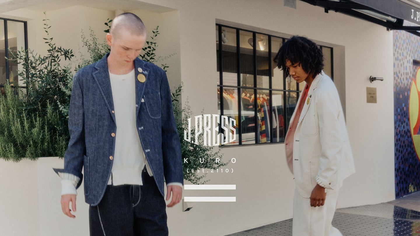 J.PRESS 店頭で、デニムジャケットの男性とオフホワイトのセットアップの女性